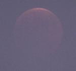 [Lunar eclipse progressing, sky darkening]