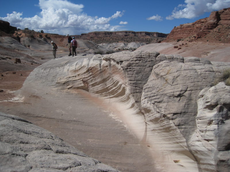 [Hikers stand above the to ...]